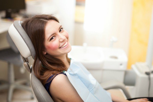 girl smiling in dentist chair